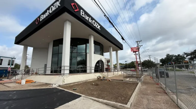 Commercial building frontage with fresh mulch beds and canopy trees in San Antonio
