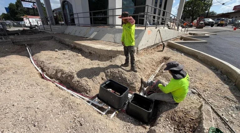 Design Scapes crew installing an irrigation valve box on a San Antonio commercial property
