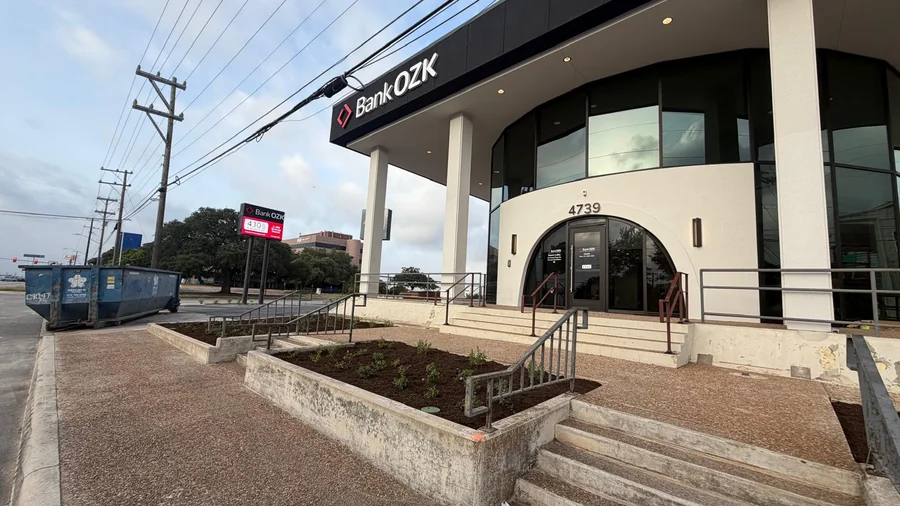 Curbed planting bed at the entrance of a San Antonio commercial building