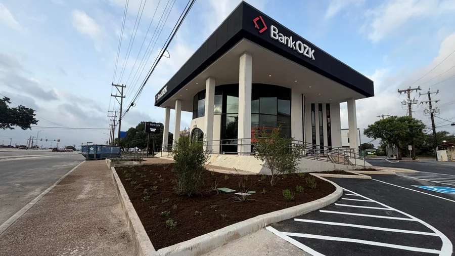 Commercial building frontage with landscaped beds and striped parking in San Antonio